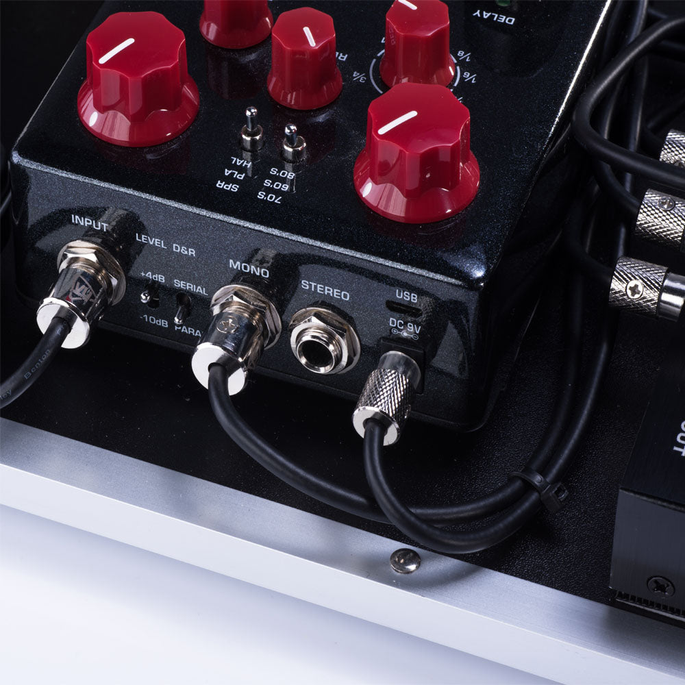 Straight and right-angle IVU patch cables connected to pedalboard equipment