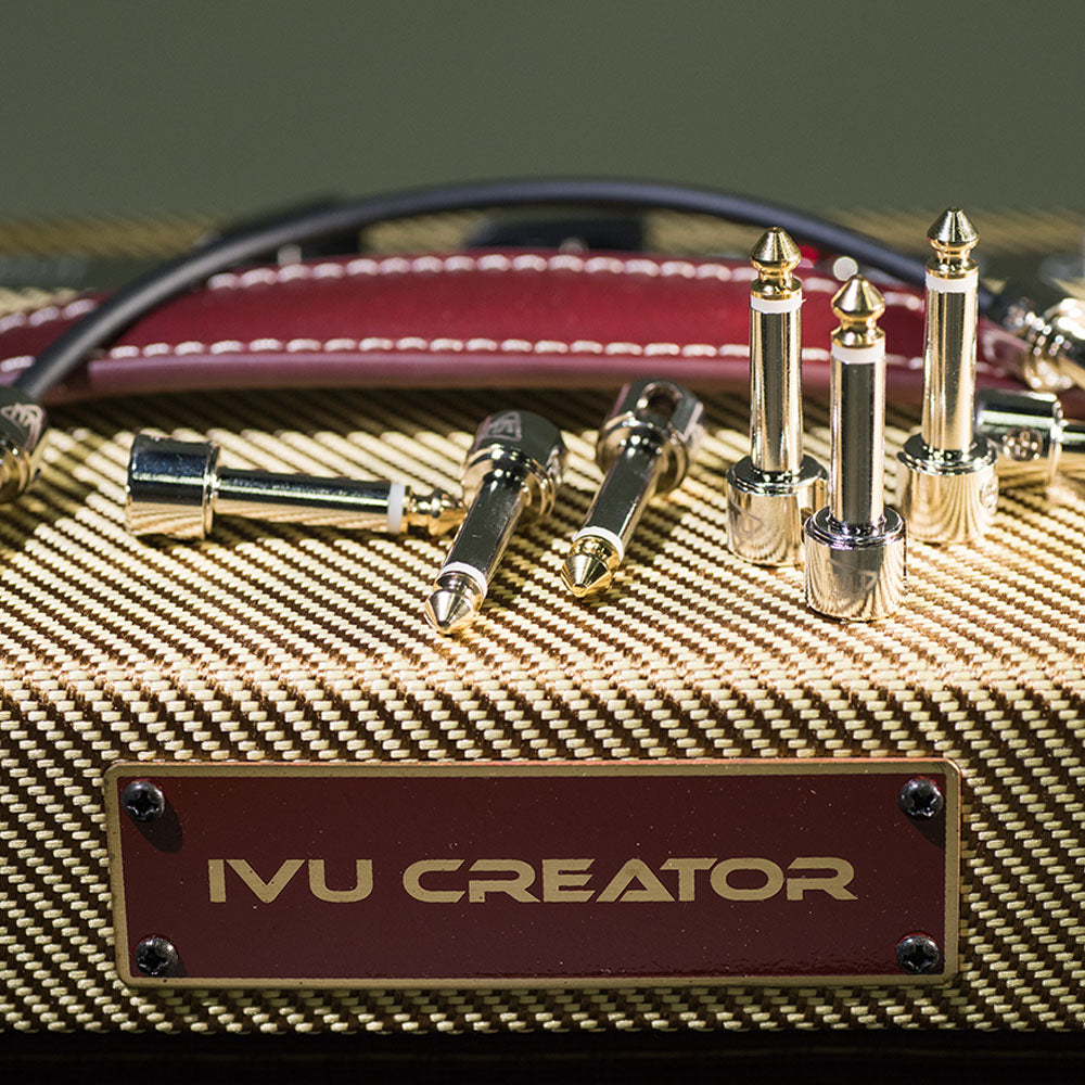 IVU Creator dual-hole 1/4-inch solderless plugs displayed on a guitar amplifier