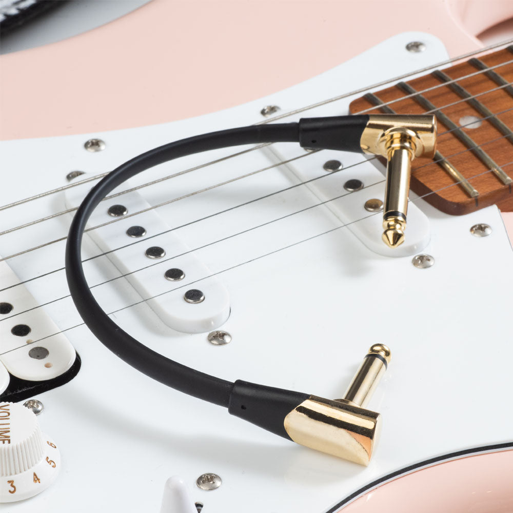 Gold-finish IVU FPC-415 patch cable shown on an electric guitar