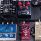 Custom DC power cables routed between guitar effects pedals on a pedalboard