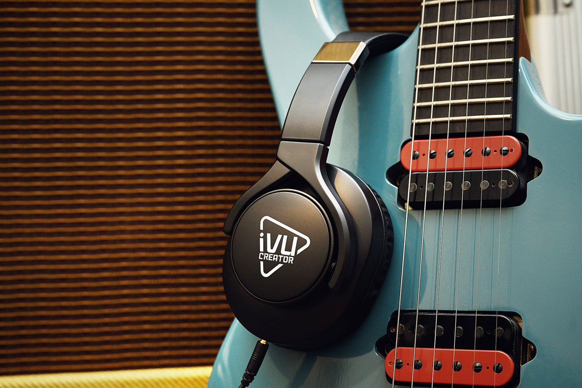 IVU SH-10 closed-back studio headphones beside an electric guitar